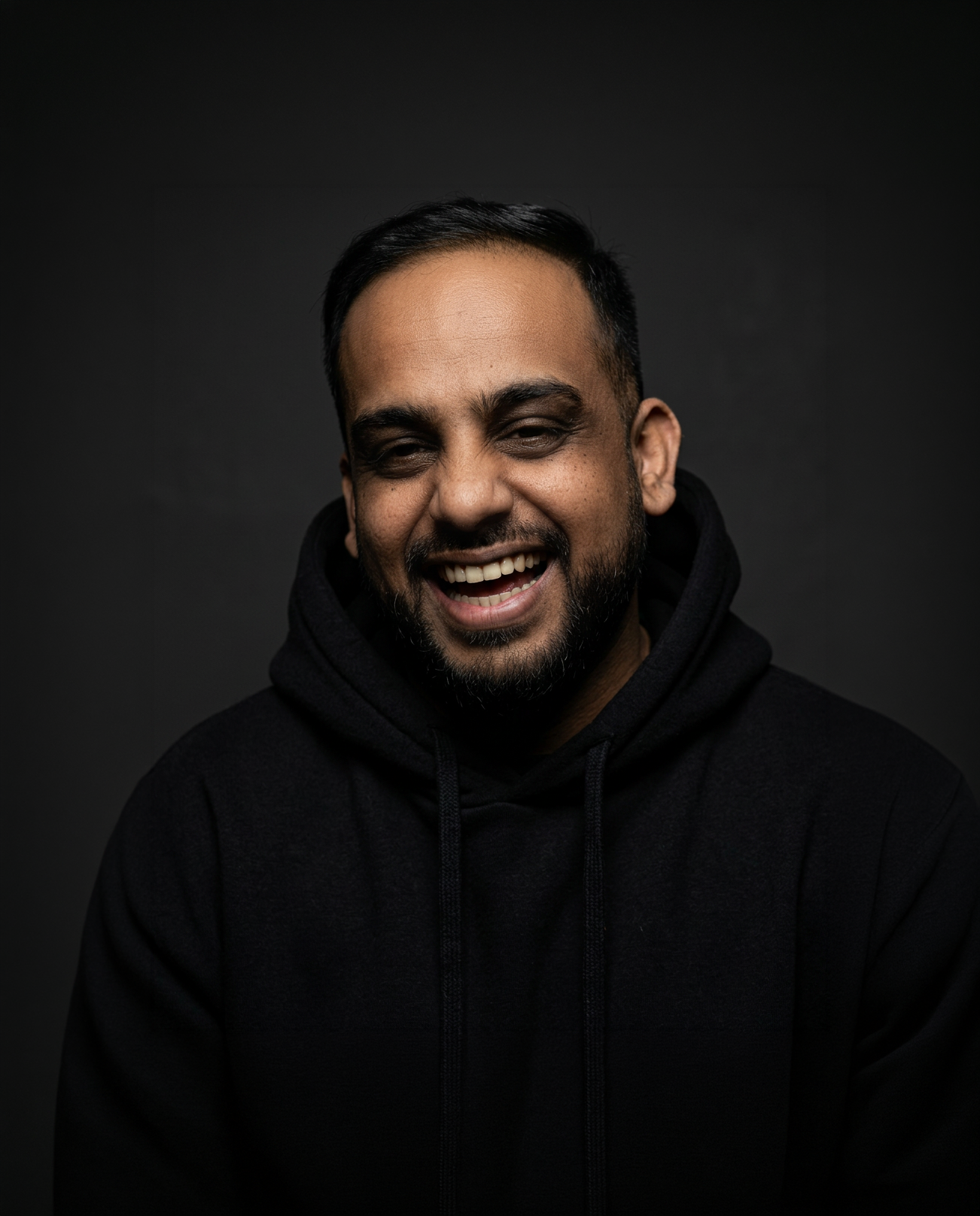 Sumeet Joseph smiling against a dark background